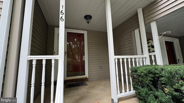 view of exterior entry with a porch