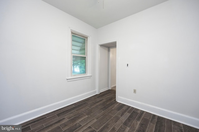 empty room with dark hardwood / wood-style floors