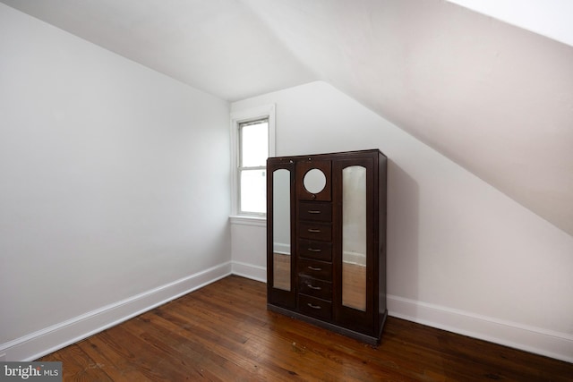 bonus room featuring vaulted ceiling and dark hardwood / wood-style floors