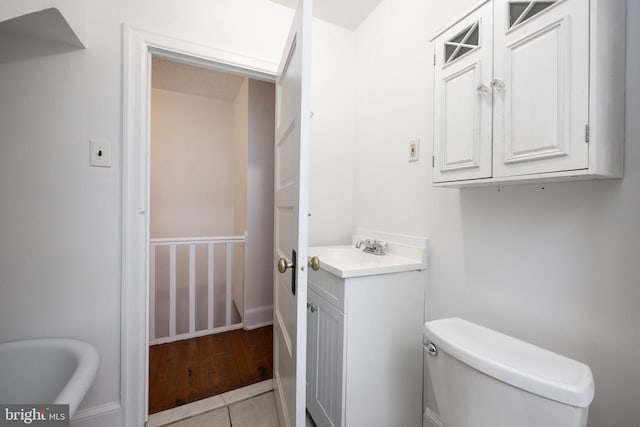 bathroom with vanity, toilet, and tile patterned floors