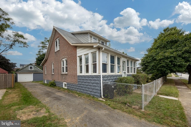 view of side of property with an outdoor structure and a garage