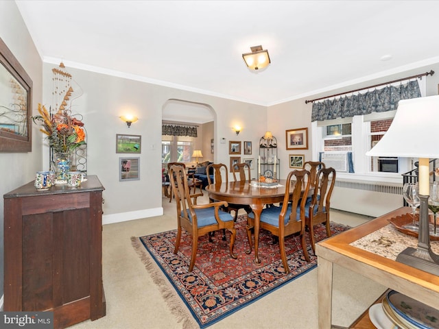 dining area featuring light colored carpet and ornamental molding