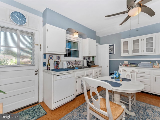 kitchen with dishwasher, light hardwood / wood-style flooring, and white cabinetry