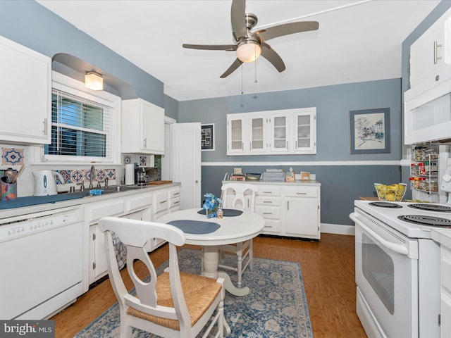 kitchen with ceiling fan, white appliances, sink, dark hardwood / wood-style flooring, and white cabinetry