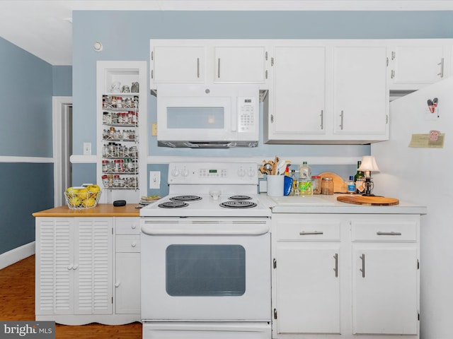 kitchen featuring wood-type flooring, white cabinets, and white appliances