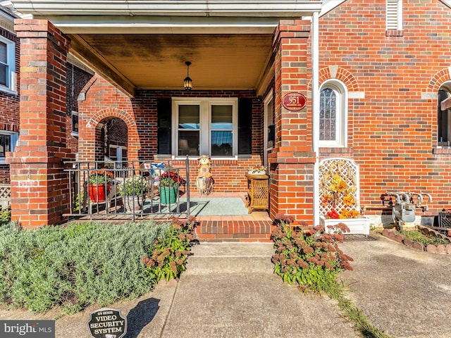 view of exterior entry with a porch