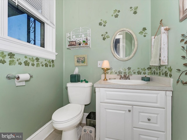 bathroom with vanity, toilet, and tile patterned floors