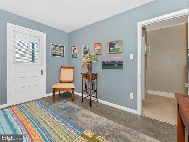 living area with dark colored carpet