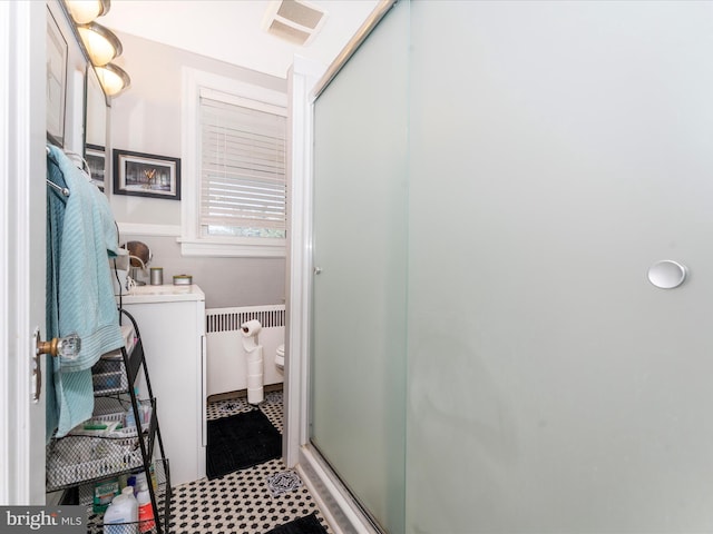 bathroom with walk in shower, vanity, and toilet