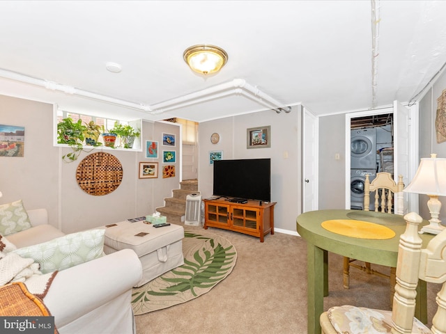 carpeted living room with stacked washer and dryer