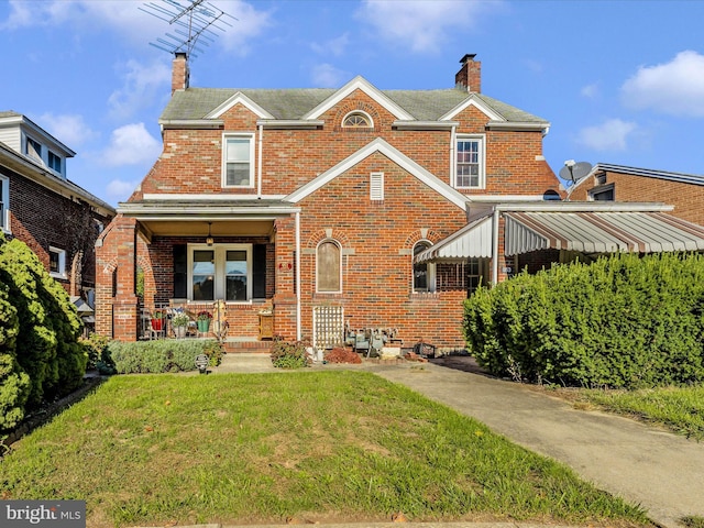 view of front facade with a porch and a front lawn