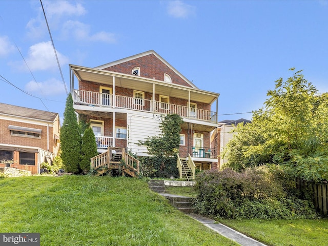 exterior space with a balcony and a lawn