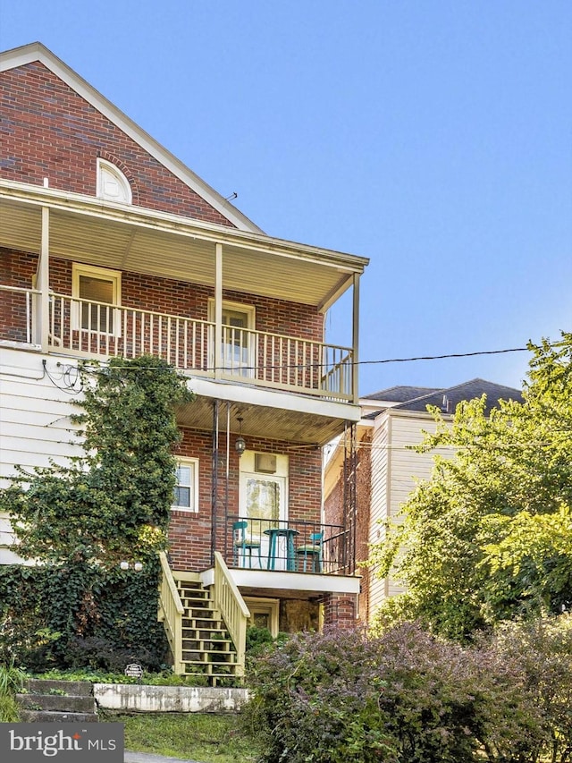 rear view of house featuring a balcony