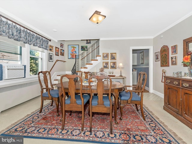 carpeted dining room featuring cooling unit, crown molding, and radiator heating unit