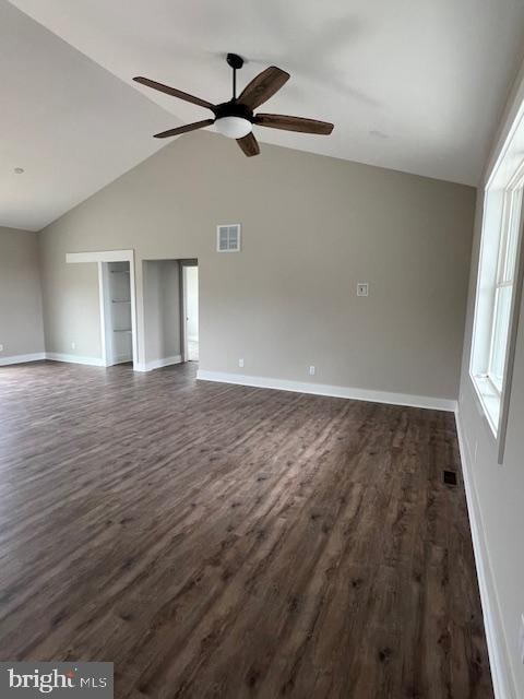 unfurnished living room with dark hardwood / wood-style flooring, vaulted ceiling, and ceiling fan