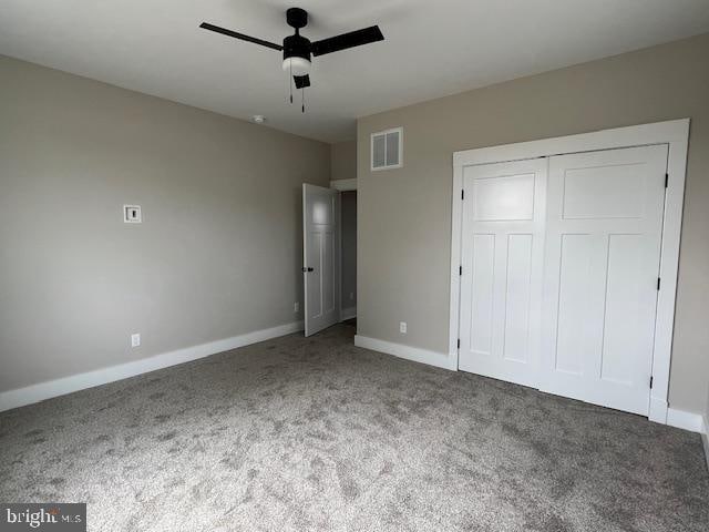 unfurnished bedroom featuring carpet flooring, a closet, and ceiling fan