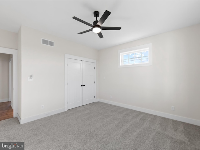 unfurnished bedroom featuring a closet, carpet, and ceiling fan