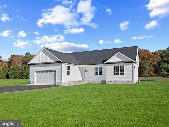 ranch-style home featuring a front yard and a garage