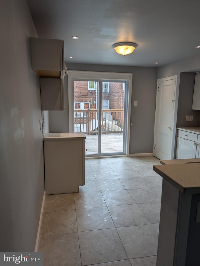 kitchen featuring kitchen peninsula and light tile patterned floors