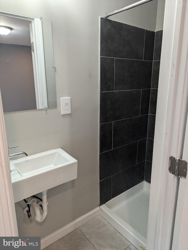 bathroom with tile patterned flooring and tiled shower