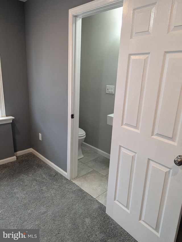 bathroom with tile patterned floors and toilet