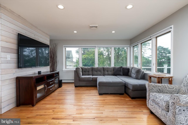 living room featuring light wood finished floors, visible vents, recessed lighting, and a baseboard radiator