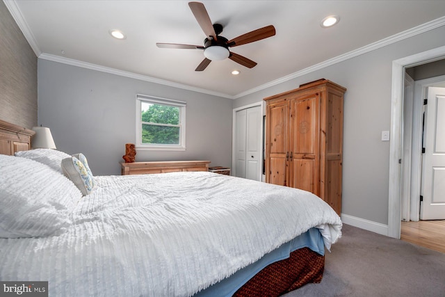 bedroom featuring ornamental molding, light carpet, a closet, and ceiling fan