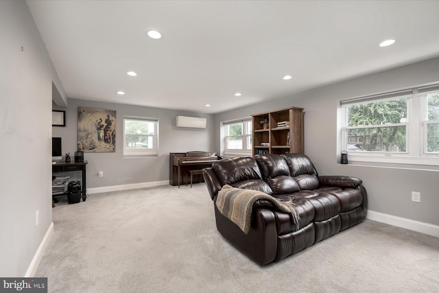 living area with recessed lighting, baseboards, a wall unit AC, and light colored carpet