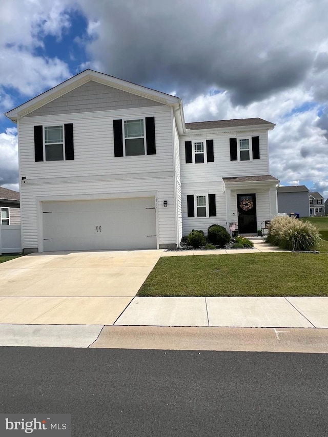 view of front of home featuring a garage and a front lawn