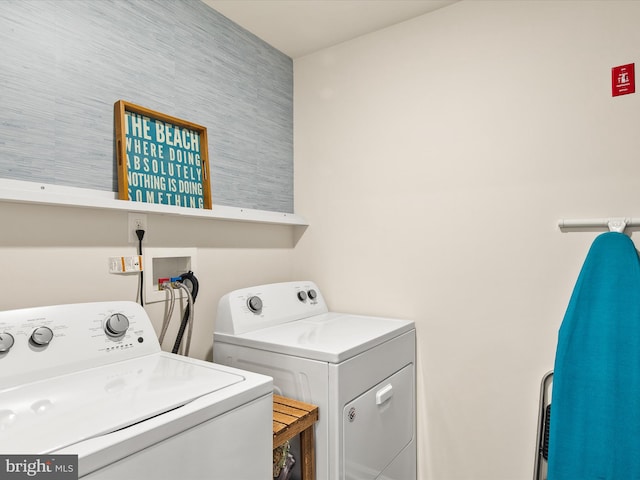 clothes washing area featuring separate washer and dryer