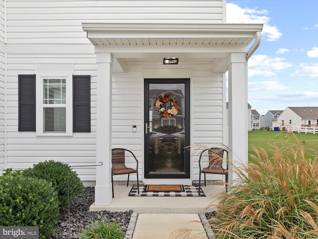 view of exterior entry with a porch