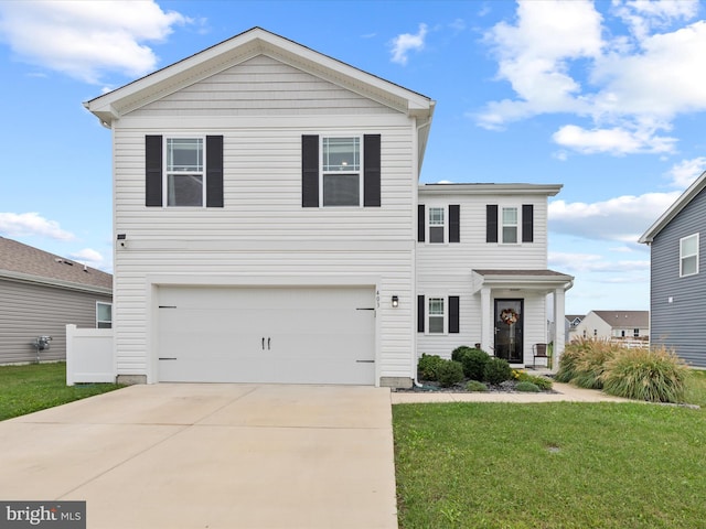 view of front of home with a front yard and a garage