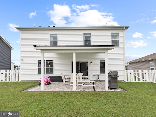 back of house featuring a yard and a patio area