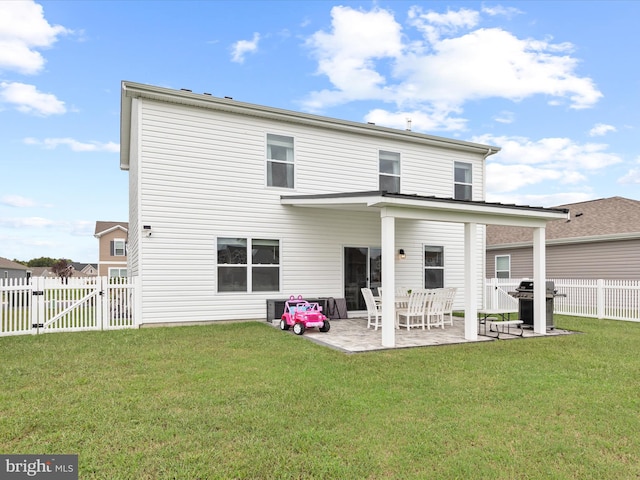 rear view of house featuring a patio area and a yard