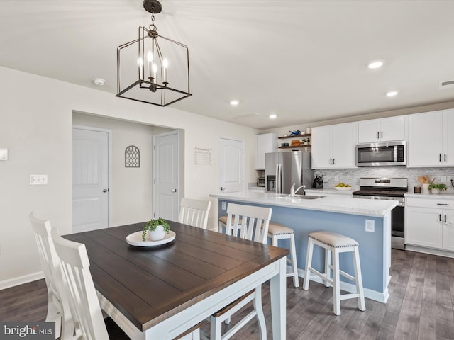 dining room featuring an inviting chandelier, dark wood-type flooring, and sink