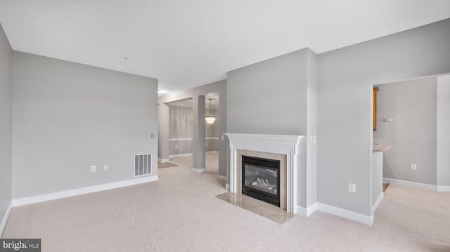 unfurnished living room featuring light carpet