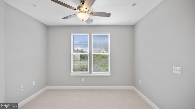 empty room with carpet, plenty of natural light, and ceiling fan