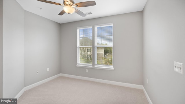 carpeted empty room featuring ceiling fan