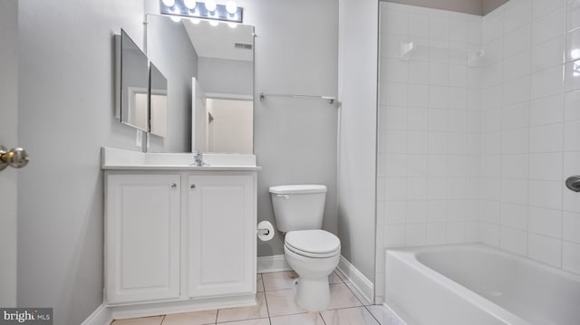 full bathroom featuring tile patterned floors, vanity, tiled shower / bath combo, and toilet