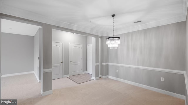 unfurnished dining area featuring light colored carpet, ornamental molding, and an inviting chandelier