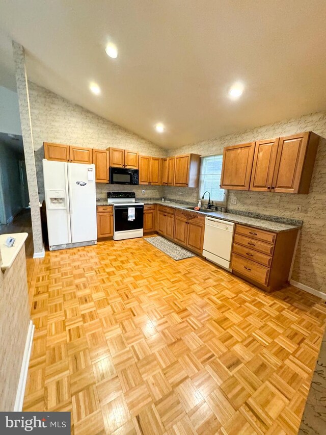 spare room featuring light hardwood / wood-style floors and vaulted ceiling