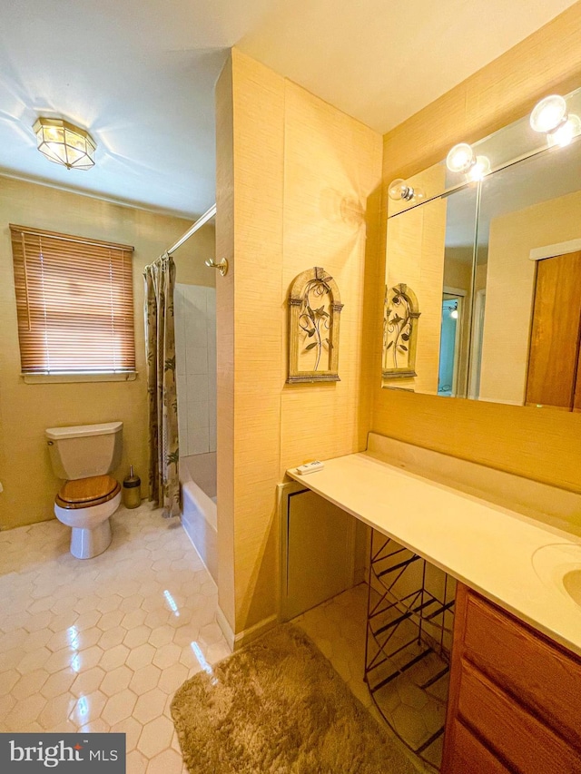 full bathroom featuring shower / bath combination with curtain, vanity, tile patterned flooring, and toilet