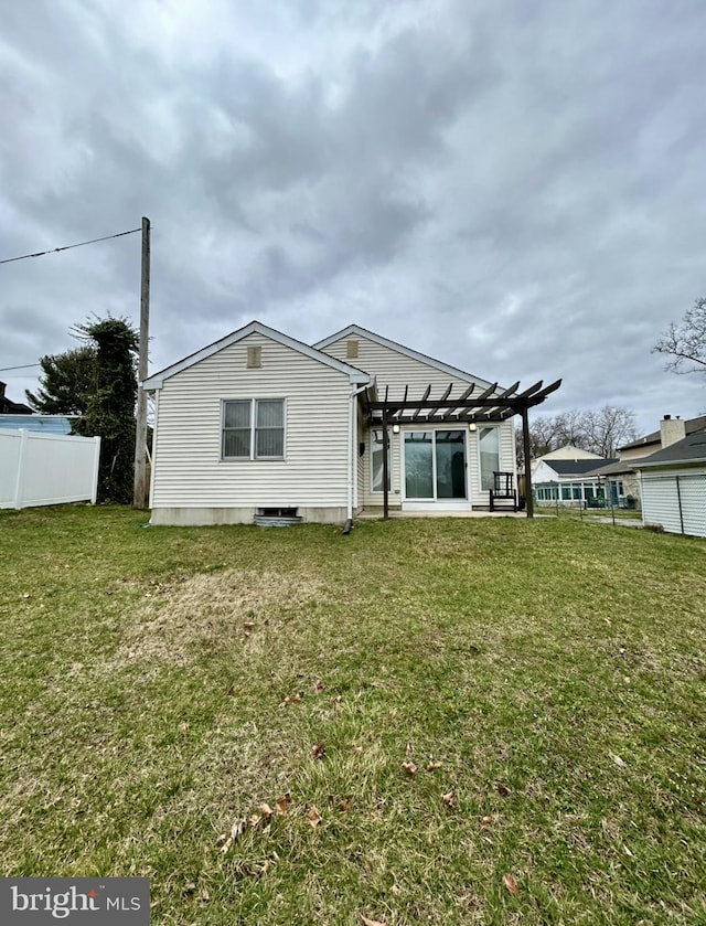 back of house with a lawn and a pergola