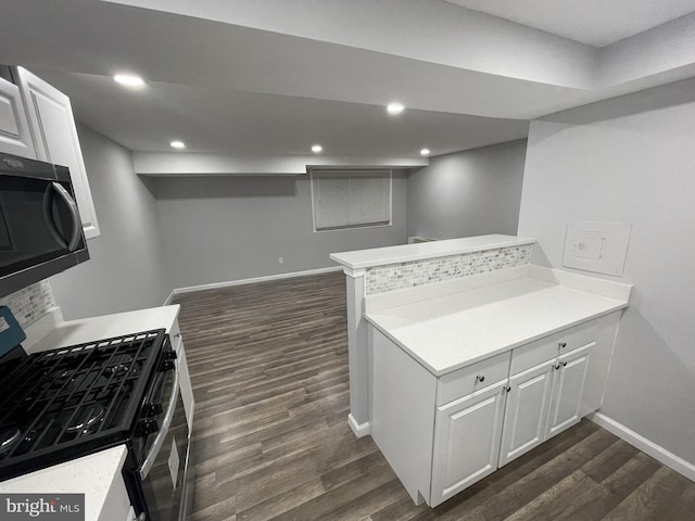 kitchen with light countertops, white cabinetry, dark wood-style floors, stainless steel gas range oven, and recessed lighting
