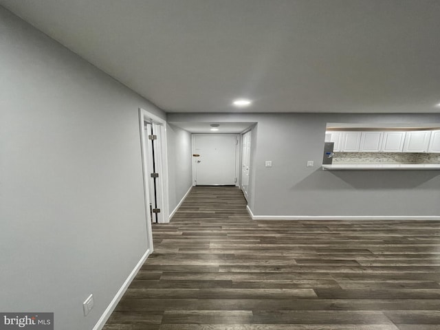 hallway with dark wood-style floors, recessed lighting, and baseboards