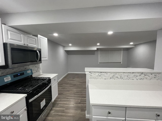 kitchen with light countertops, white cabinetry, tasteful backsplash, dark wood finished floors, and stainless steel appliances