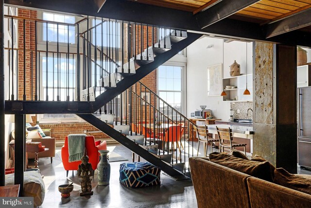 interior space with wooden ceiling, plenty of natural light, and a fireplace