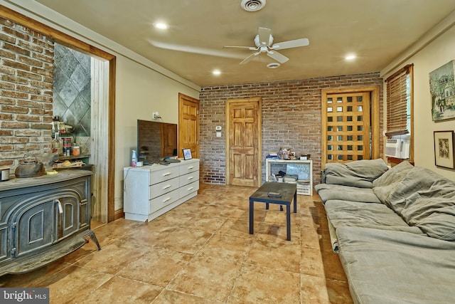 living room with brick wall, cooling unit, and ceiling fan