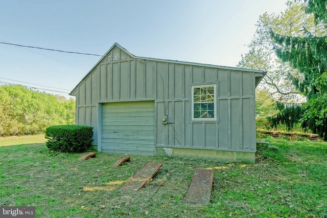 view of outbuilding with a lawn and a garage