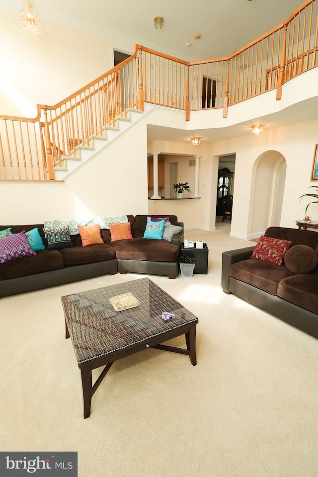 carpeted living room with a high ceiling